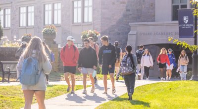 Students walking in front of campus building.