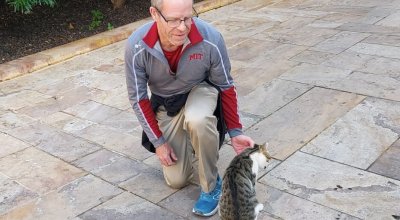 Dr. Chad Raymond petting a cat in Jordan during sabbatical in 2024.