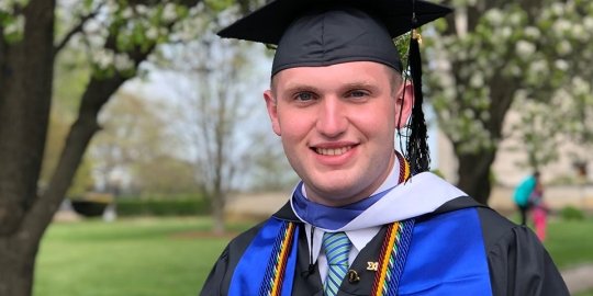 Salve master's in criminal justice and cybersecurity graduate in cap and gown