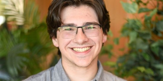 Male student smiling looking at camera