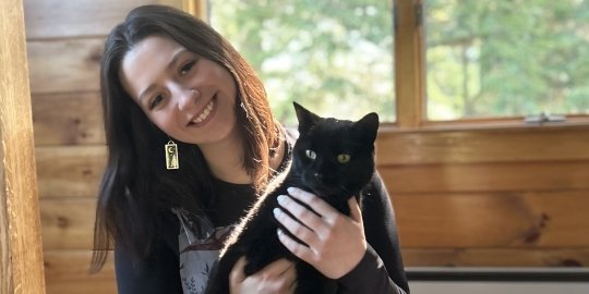 Photo of Jacqueline Wilson holding a black cat