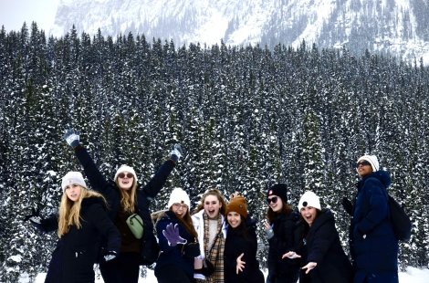 Dance students pose in the snow at Lake Louise in Canada