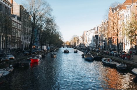 A canal lined with boats in Amsterdam, Netherlands