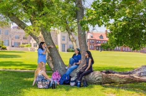 Students hang out behind O'Hare Academic Building alongside Cliff Walk.