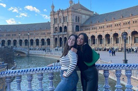 Students on a bridge over a canal in a European city