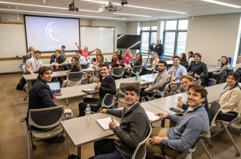 A classroom full of students participate in a We Mean Business session