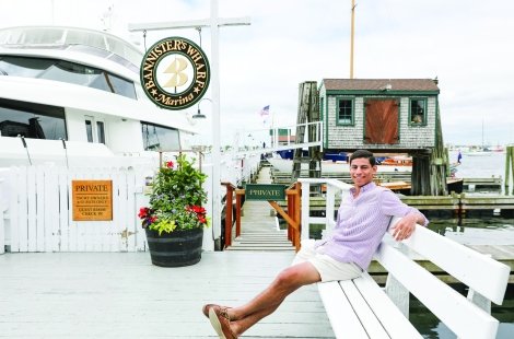 student sitting on a bench at Bannister's wharf