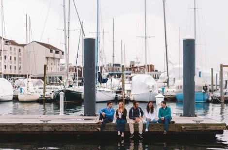 students sitting on dock