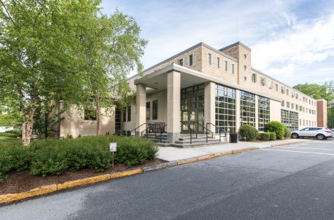 A brick building with a wall of windows on one side