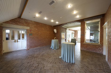 A large lobby area with cocktail tables.