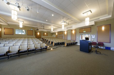 A small lecture hall with a podium at the front.