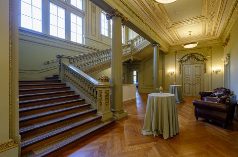 A small lobby area with a wide staircase on the left side.