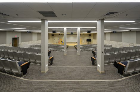 A large lecture hall with a wide center aisle.