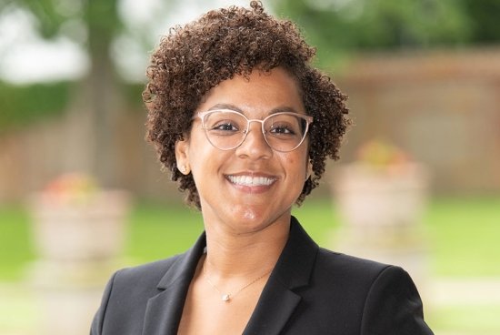 Close-up of a woman in glasses wearing a suit