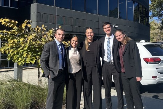 four students in business attire outside Siemens headquarters
