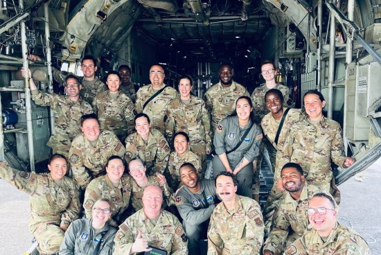 Group photo of Rose and other people in their Air Force uniforms on a plane.