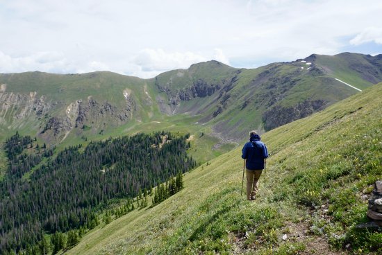 Dr. Jameson Chace hiking in the green mountains of Colorado.