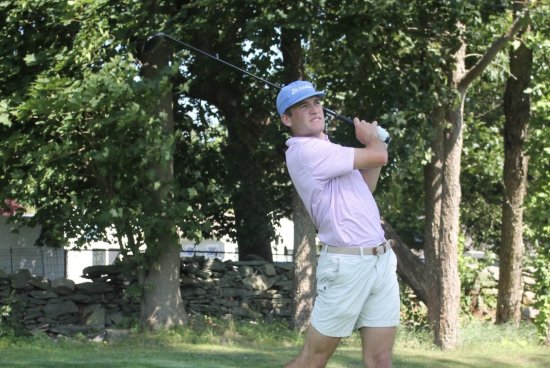 Jack swinging a golf club on the green.