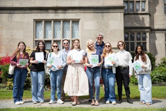 Group photo of the "Walking Through History" program students holding their scavenger hunts.