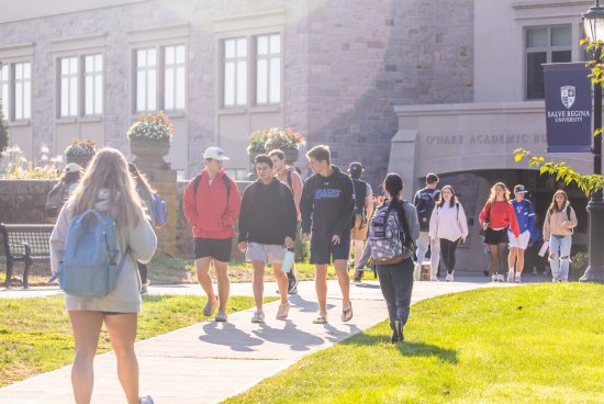 Students walking in front of campus building.
