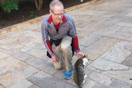 Dr. Chad Raymond petting a cat in Jordan during sabbatical in 2024.