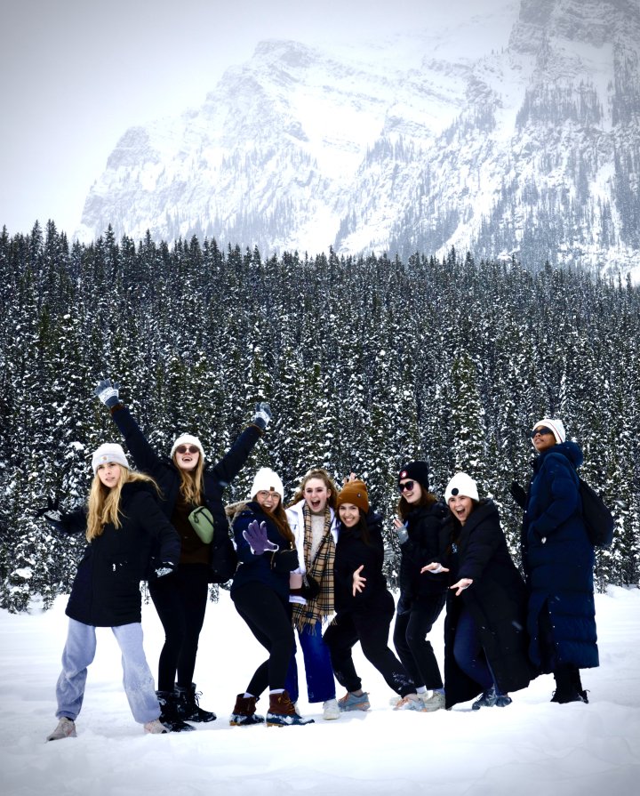 Dance students pose in the snow at Lake Louise in Canada