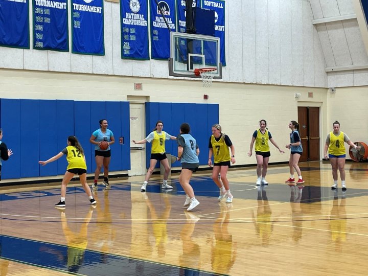 A group of women playing basketball on an indoor court