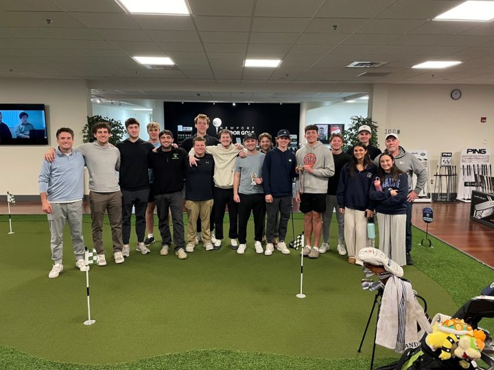 A group of people at an indoor golf facility