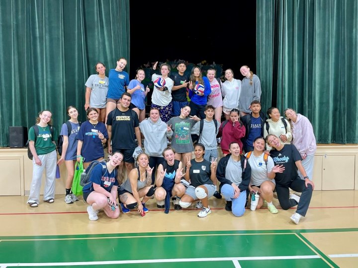 A group of people on a volleyball court