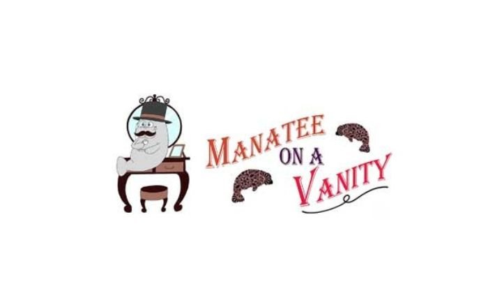 A manatee wearing a crown sitting on a vanity, with the company name to the right of the image