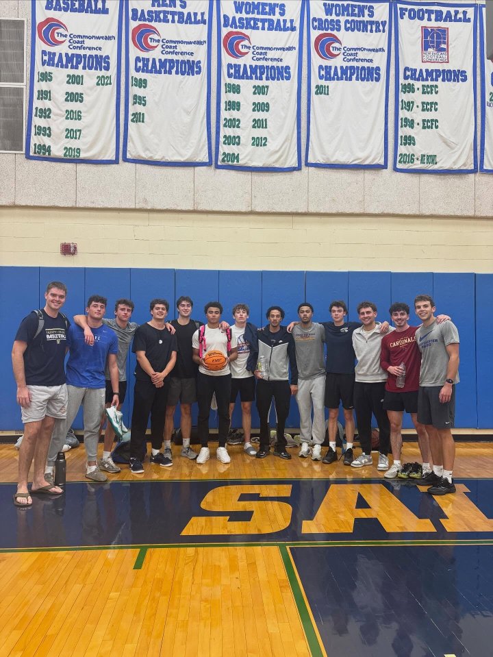 A group of 13 men on a basketball court