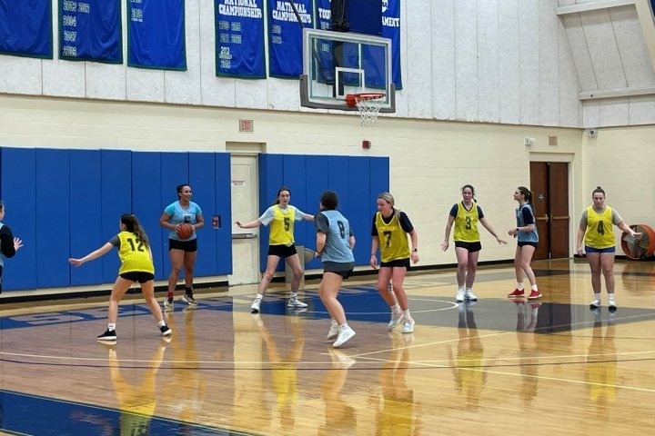 A group of women playing basketball on an indoor court