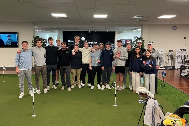 A group of people at an indoor golf facility