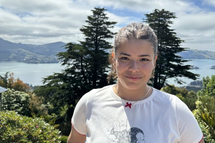 Emily Bernardo with New Zealand coast in the background