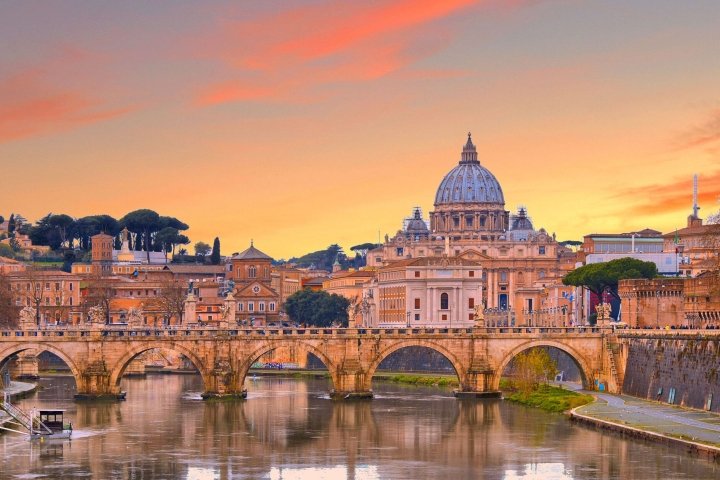 Roman buildings and arches over a waterway against a golden sky