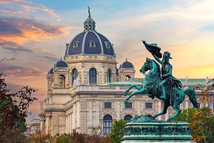 Domed marble building with bronze statue in front