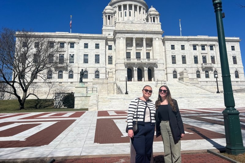 Two students standing outside of the RI State House