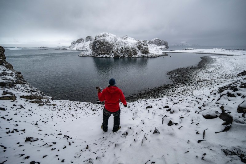 Kitchel carrying artifacts recovered from an 1820s seal hunter site on Cave Island.