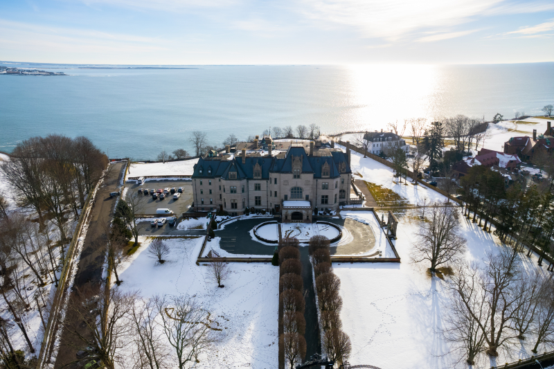 Drone shot of the exterior of Ochre Court in the winter with snow on the ground.