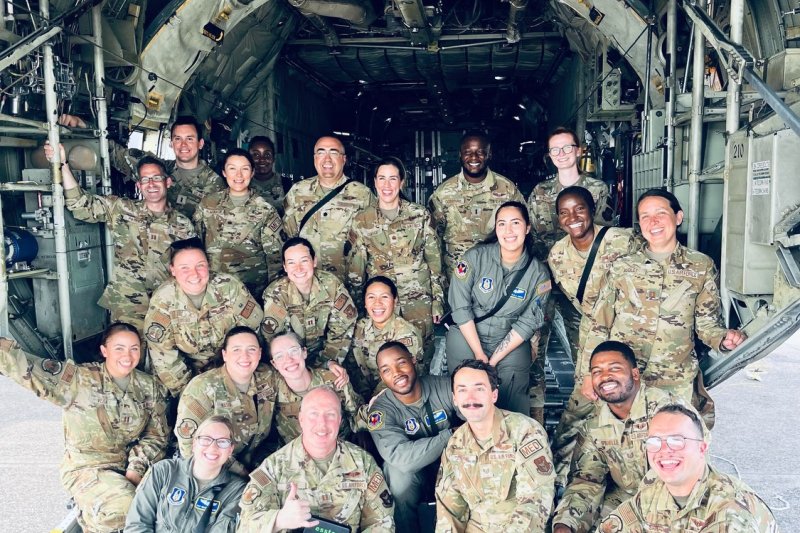 Group photo of Rose and other people in their Air Force uniforms on a plane.