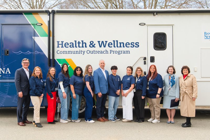 BankNewport, Harvard Pilgrim Health Care and Tufts Health Plan joining the Health and Wellness Community Outreach Program outside the mobile unit.