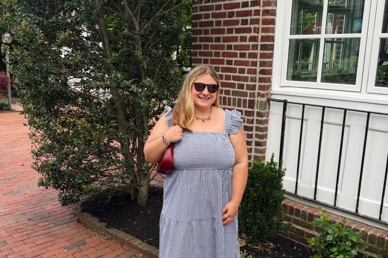 Morgan Rizzo smiles outside a brick building.