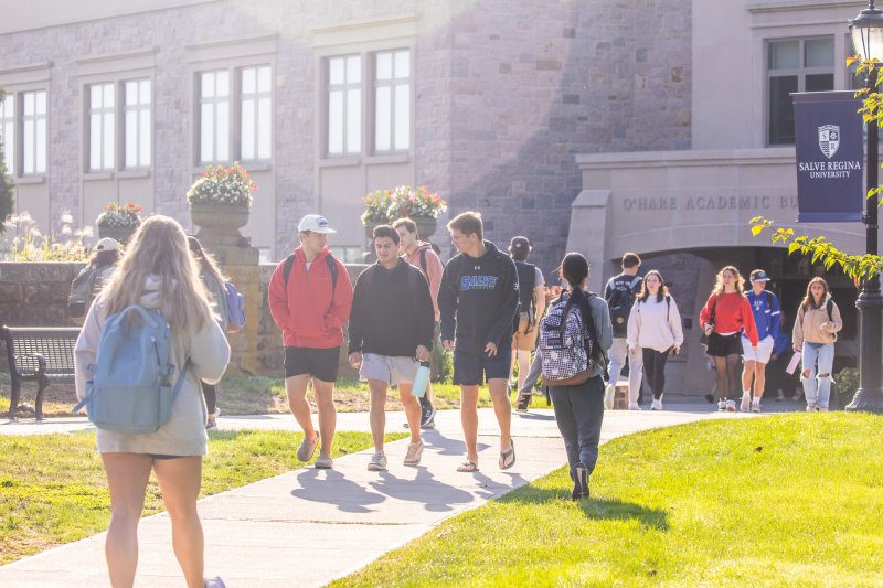 Students walking in front of campus building.