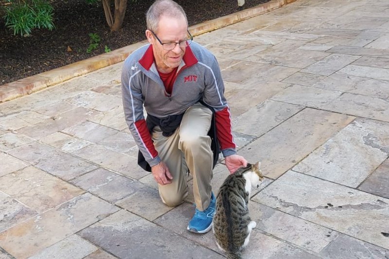 Dr. Chad Raymond petting a cat in Jordan during sabbatical in 2024.