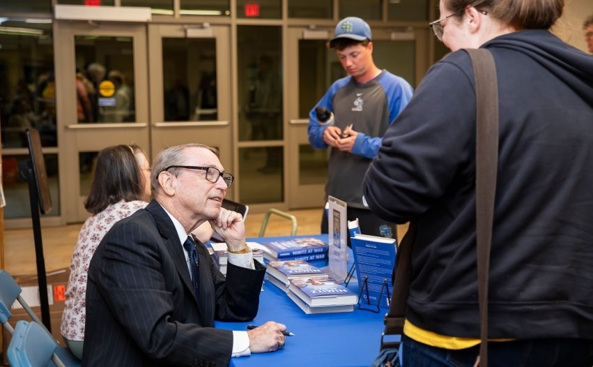 Symonds' signing a copy of his book