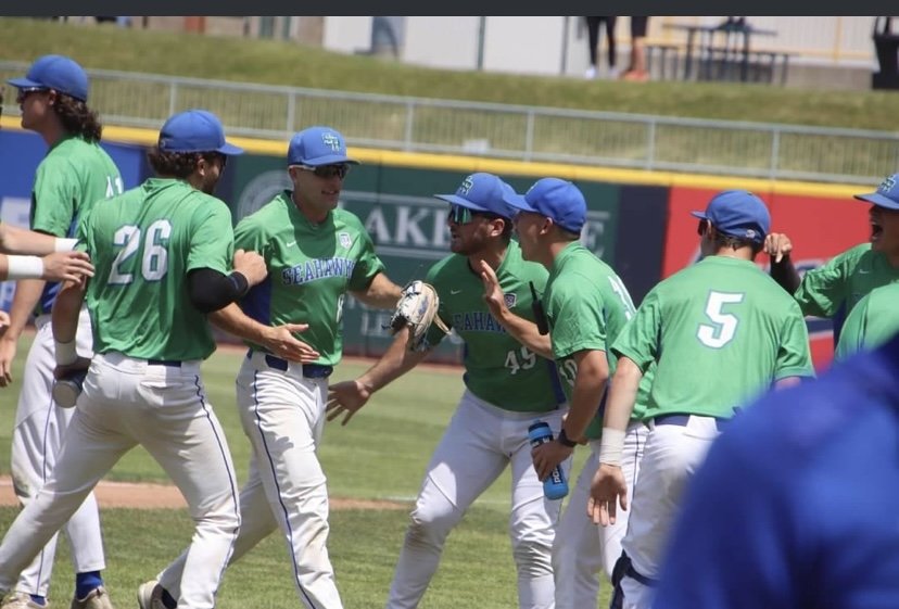 Brandon Grover '24 '25 (MBA) celebrating with his teammates on the field.