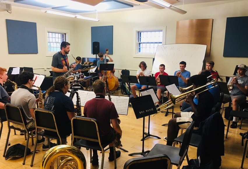 students in a music room playing jazz instruments with instructor