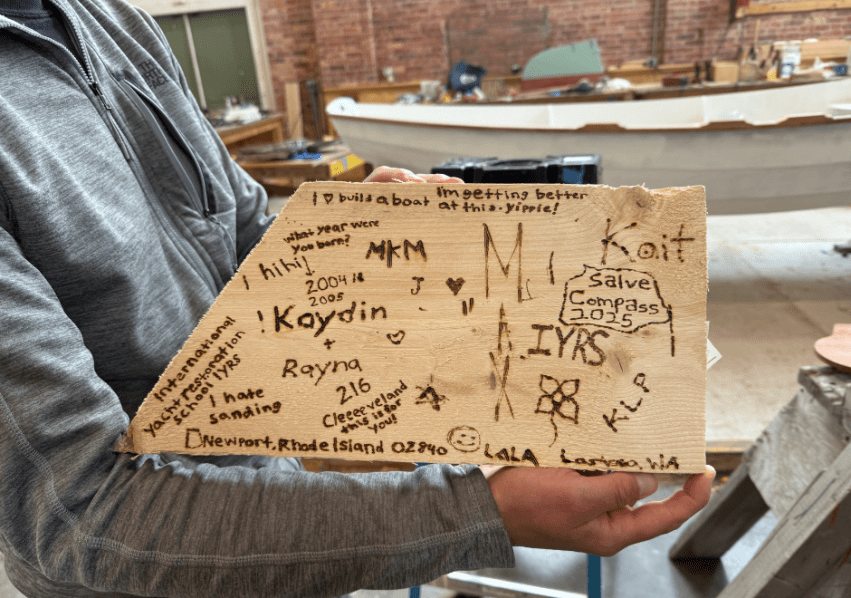 A wooden rudder that the students shaped and signed with their names, inside jokes and memories.
