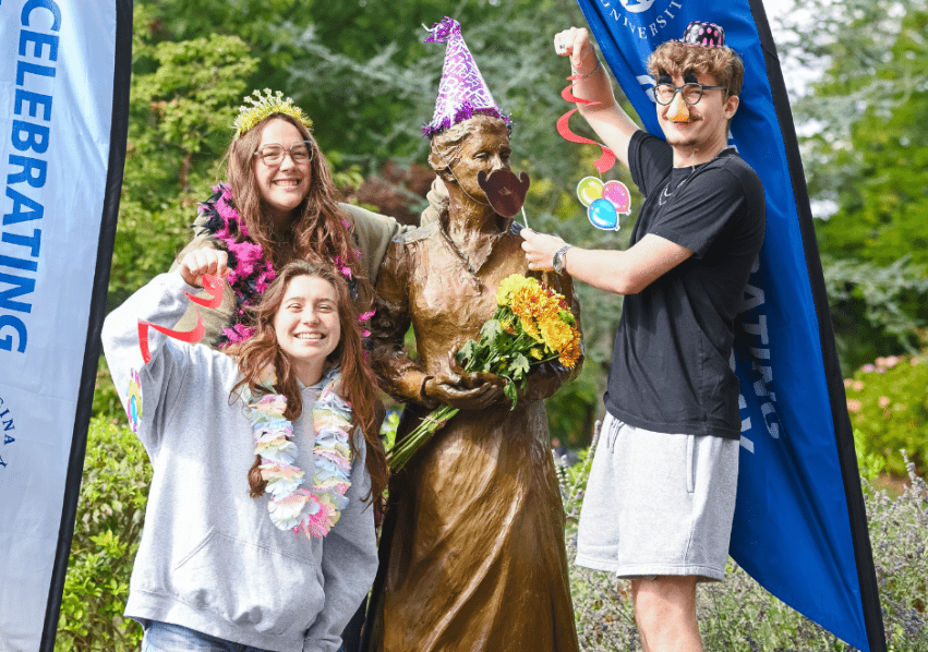 Students posing with the statue of Catherine McAuley to celebrate her birthday.