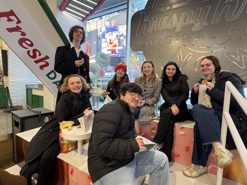 Students enjoying Krispy Kreme donuts.